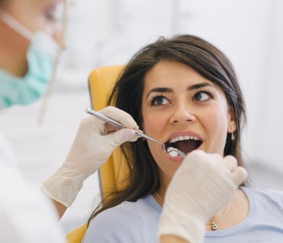 Woman receiving cracked tooth treatment from her dentist