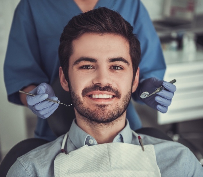 Man smiling in dental chair at Jersey City dental office